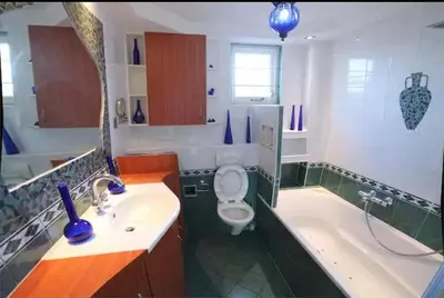 a bathroom with a sink and a toilet and a tub at Villa with garden near Amsterdam in Almere