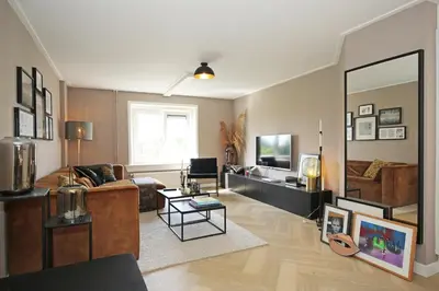 a living room with a couch and a mirror at Bright City Retreat near Center & RAI in Amsterdam
