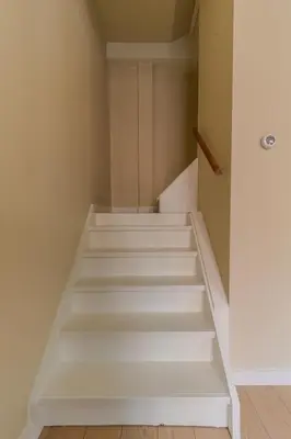 a staircase with white steps in a room at City & Trainhouse in Alkmaar