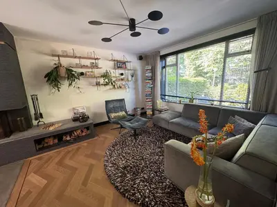 a living room with a couch and a fireplace at Family home Amsterdam Zuid - South in Amsterdam