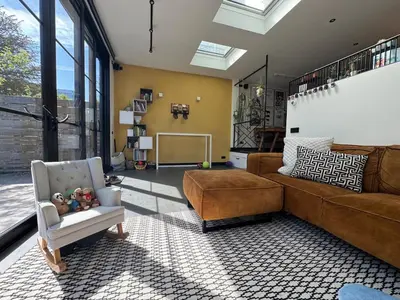 a living room with a couch and a chair at Family home Amsterdam Zuid - South in Amsterdam