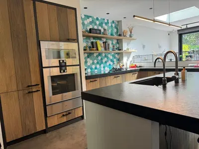 a kitchen with a sink and a stove top oven at Family home Amsterdam Zuid - South in Amsterdam