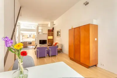 a living room with a vase of flowers on a table at Voldersgracht Canal Home Haarlem in Haarlem