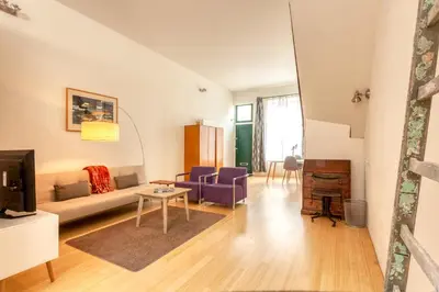a living room with a couch and a table at Voldersgracht Canal Home Haarlem in Haarlem