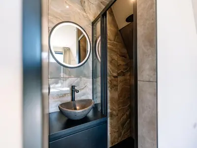 a bathroom with a bowl sink and a mirror at Stay with Private Pool & Hot Tub in Waarland