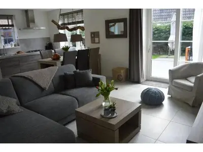 a living room with a couch and a table at Waddengoud in Ons Belang