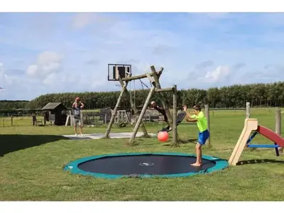 a young boy playing with a ball on a trampoline at Waddengoud in Ons Belang