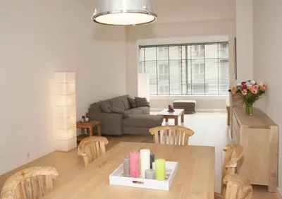 a living room with a table and chairs and a couch at Casa Del Cisne in Zandvoort