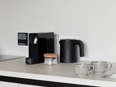 a coffee maker and two cups on a counter at Numa Amsterdam Vondelpark in Amsterdam