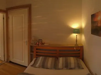 a bedroom with a bed with a lamp on it at Apartment in Zandvoort with swimming pool in Zandvoort