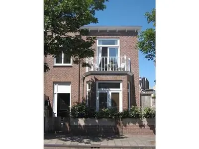 a brick house with a balcony on the side of it at Apartment in Zandvoort with swimming pool in Zandvoort