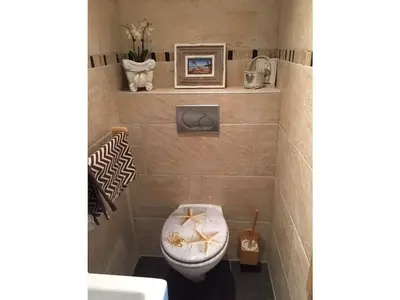 a bathroom with a toilet with a towel on the seat at Apartment in Zandvoort with swimming pool in Zandvoort