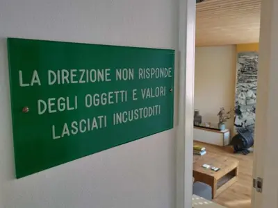 a green sign on a wall in a room at Centraal aan Zee in Egmond aan Zee