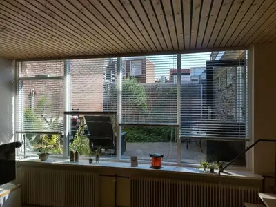 a large window with a view of a city at Centraal aan Zee in Egmond aan Zee