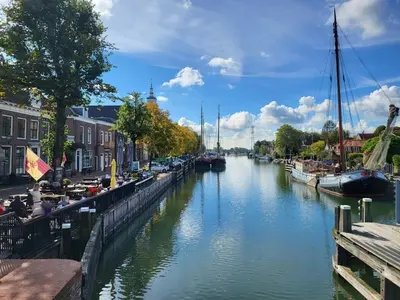 a river with boats parked on the side of it at Apartment in Naarden with swimming pool in Naarden