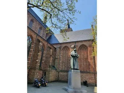 a statue of a woman in front of a building at Apartment in Naarden with swimming pool in Naarden