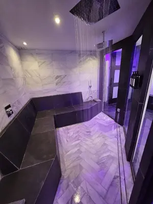 a room with a tub with purple lights in it at Bed & Wellness Malina deluxe in Lelystad