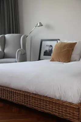 a bedroom with a bed and a chair and a lamp at Entire home with direct Vondelpark view in Amsterdam