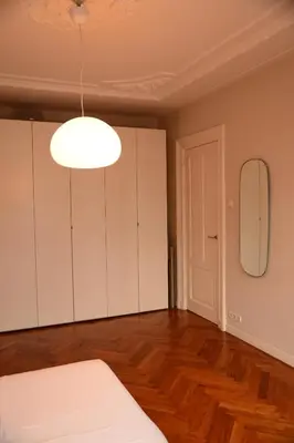 an empty room with white cabinets and a mirror at Entire home with direct Vondelpark view in Amsterdam