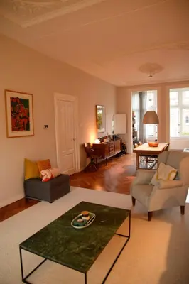 a living room with a couch and a table at Entire home with direct Vondelpark view in Amsterdam