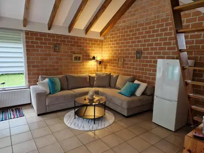 a living room with a couch and a table at Ferienhaus Sunny's Place in Egmond aan den Hoef