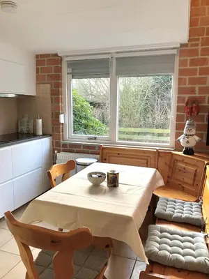 a kitchen with a table and chairs in a room at Ferienhaus Sunny's Place in Egmond aan den Hoef