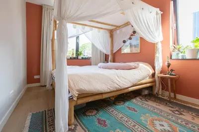 a bedroom with a canopy bed and a rug at Villa Lollipop, Amsterdam North in Amsterdam