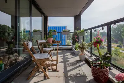 a balcony with a table and chairs and potted plants at Villa Lollipop, Amsterdam North in Amsterdam