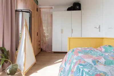 a bedroom with a bed and white cabinets at Villa Lollipop, Amsterdam North in Amsterdam