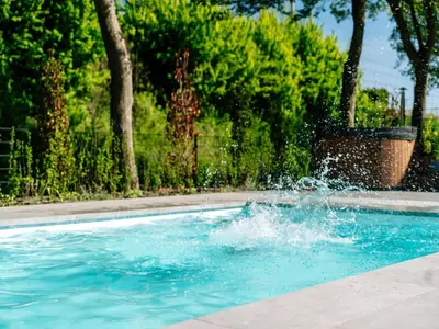 a person is splashing in a swimming pool at Beautiful holiday home in Waarland in Waarland