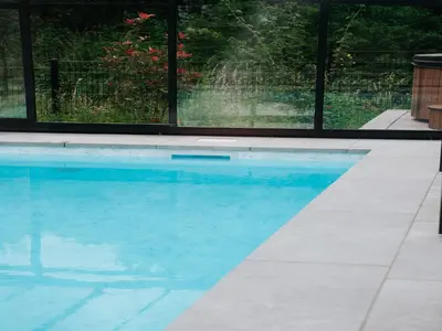 a swimming pool with blue water in a house at Beautiful holiday home in Waarland in Waarland