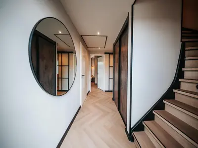 a hallway of a house with a mirror on the wall at Beautiful holiday home in Waarland in Waarland