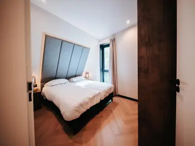 a bedroom with a large bed with a large headboard at Beautiful holiday home in Waarland in Waarland