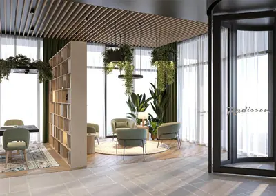 a lobby with chairs and a table and windows at Radisson Hotel Amsterdam Schiphol Airport Hoofddorp in Hoofddorp