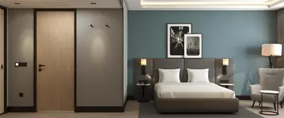 a bedroom with a bed and a table and a chair at Radisson Hotel Amsterdam Schiphol Airport Hoofddorp in Hoofddorp