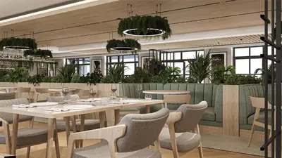 a dining room with tables and chairs and plants at Radisson Hotel Amsterdam Schiphol Airport Hoofddorp in Hoofddorp