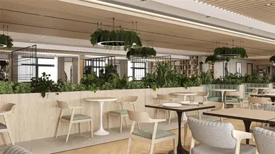 a restaurant with tables and chairs and plants at Radisson Hotel Amsterdam Schiphol Airport Hoofddorp in Hoofddorp