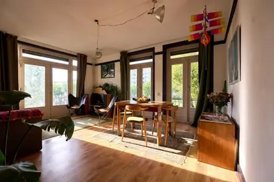 a living room with a table and chairs at Olympic's Little Palace in Amsterdam