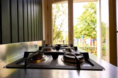 a stove top with some pots and pans on it at Olympic's Little Palace in Amsterdam