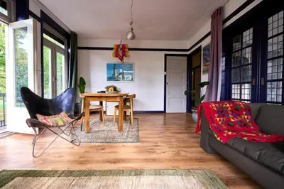 a living room with a table and a couch at Olympic's Little Palace in Amsterdam