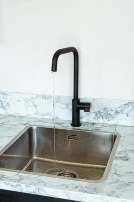 a kitchen sink with a water faucet at Kaag Villas in Warmond