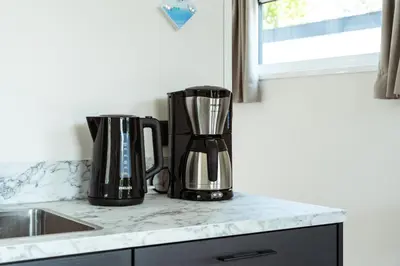 two black appliances sitting on a counter in a kitchen at Kaag Villas in Warmond