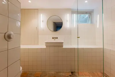 a bathroom with a sink and a mirror at Charming souterrain studio at Bloemgracht 30 in Amsterdam
