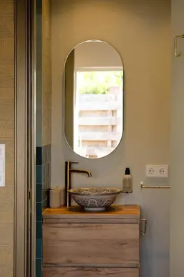 a bathroom with a sink and a mirror at Moyeni in Zandvoort