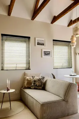 a living room with a couch and two windows at Moyeni in Zandvoort