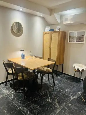 a wooden table and chairs in a room at Duin 10 in Katwijk aan Zee