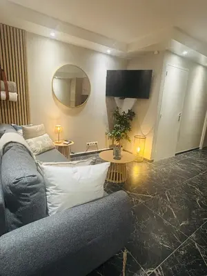 a living room with a couch and a mirror at Duin 10 in Katwijk aan Zee