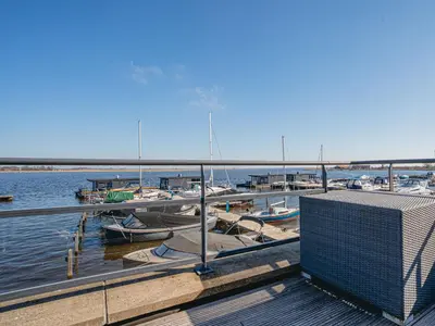 a dock with boats docked in the water at Apartment Oostergeest 2 by Interhome in Uitgeest