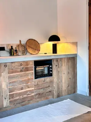 a kitchen with a wooden counter with a microwave at B&B Molenweg in Laren