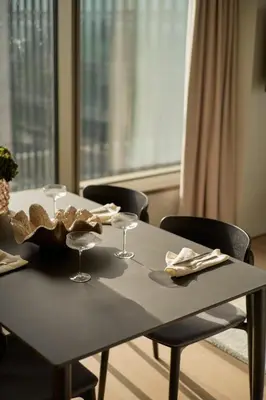 a table with wine glasses on it with chairs at Wilde Aparthotels Amsterdam Noord in Amsterdam